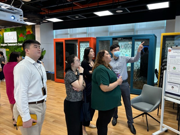  ​SGH executive and citizen developer Hsu Wenkai (extreme right) explaining his project at the SGH RPA Showcase 2024.  Photo credit Artificial Intelligence & Automation, Future Health System, Singapore General Hospital  