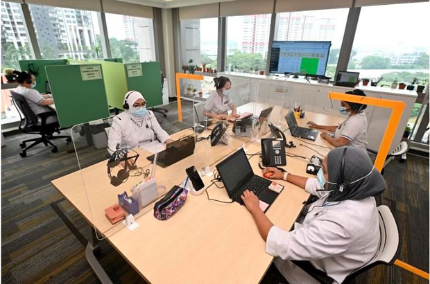  ​Nurses doing video consultations and reviewing patients' conditions at the SGH@Home Command Centre in September 2022. PHOTO ST FILE 