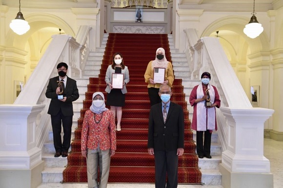 President Halimah Yacob and Minister Masagos Zulkifli with the award winners at the Istana on Nov 23, 2021.ST PHOTO DESMOND FOO