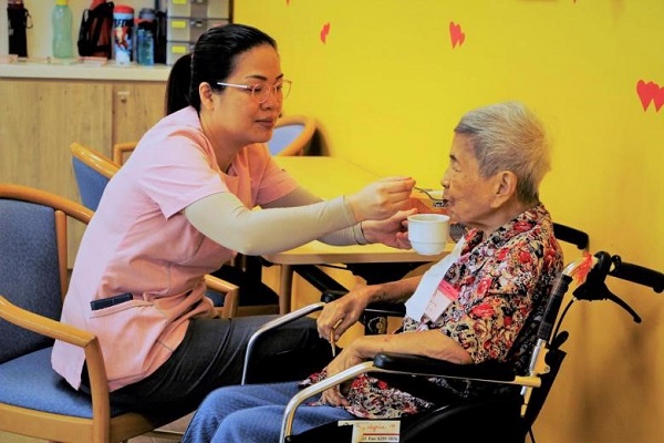 A patient being fed and cared for at the HCA Hospice Care in Serangoon. PHOTO HCA HOSPICE CARE