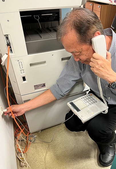 NHCS Support Services Edmund Khoo checking telephone line