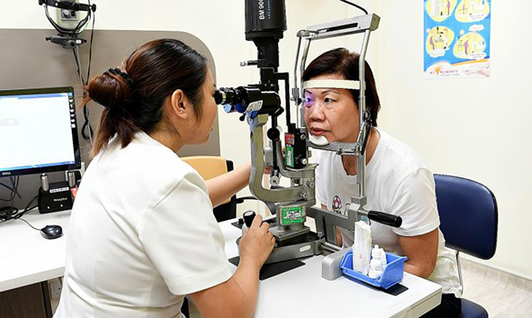  ​checking a patient's eye pressure at the SNEC clinic. The virtual clinic has cut down waiting time for low-risk patients by calling them with test results and scheduling appointments. ST PHOTO KHALID BABA